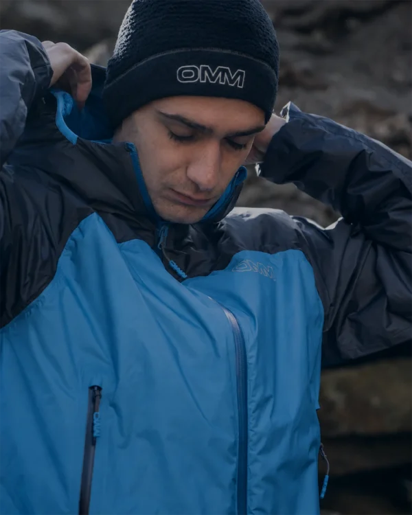 Runner putting on an OMM waterproof jacket