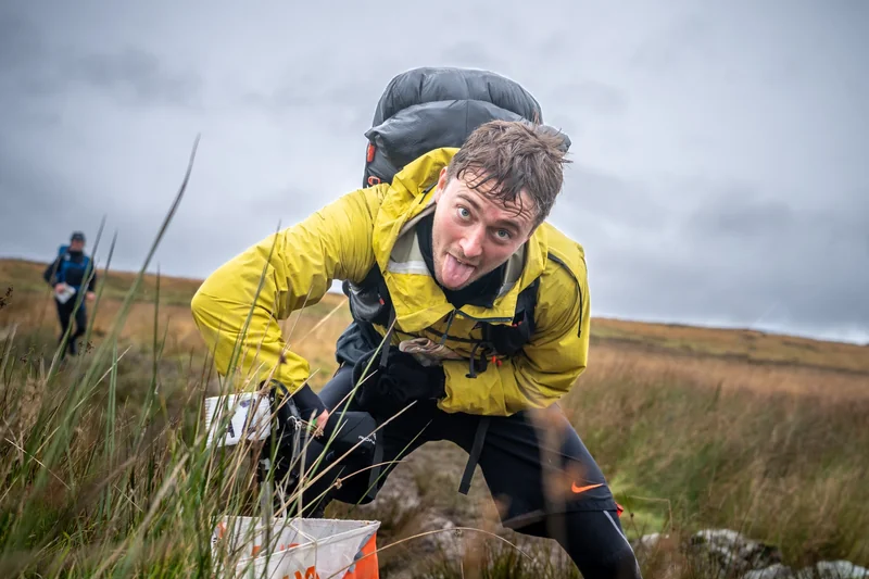 OMM competitors exploring mountain terrain
