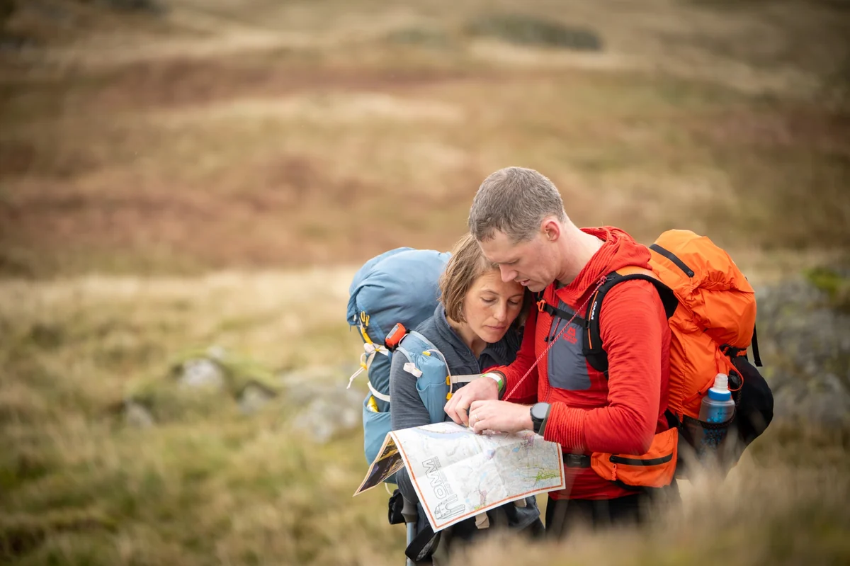 Mixed team discussing route options looking at a map