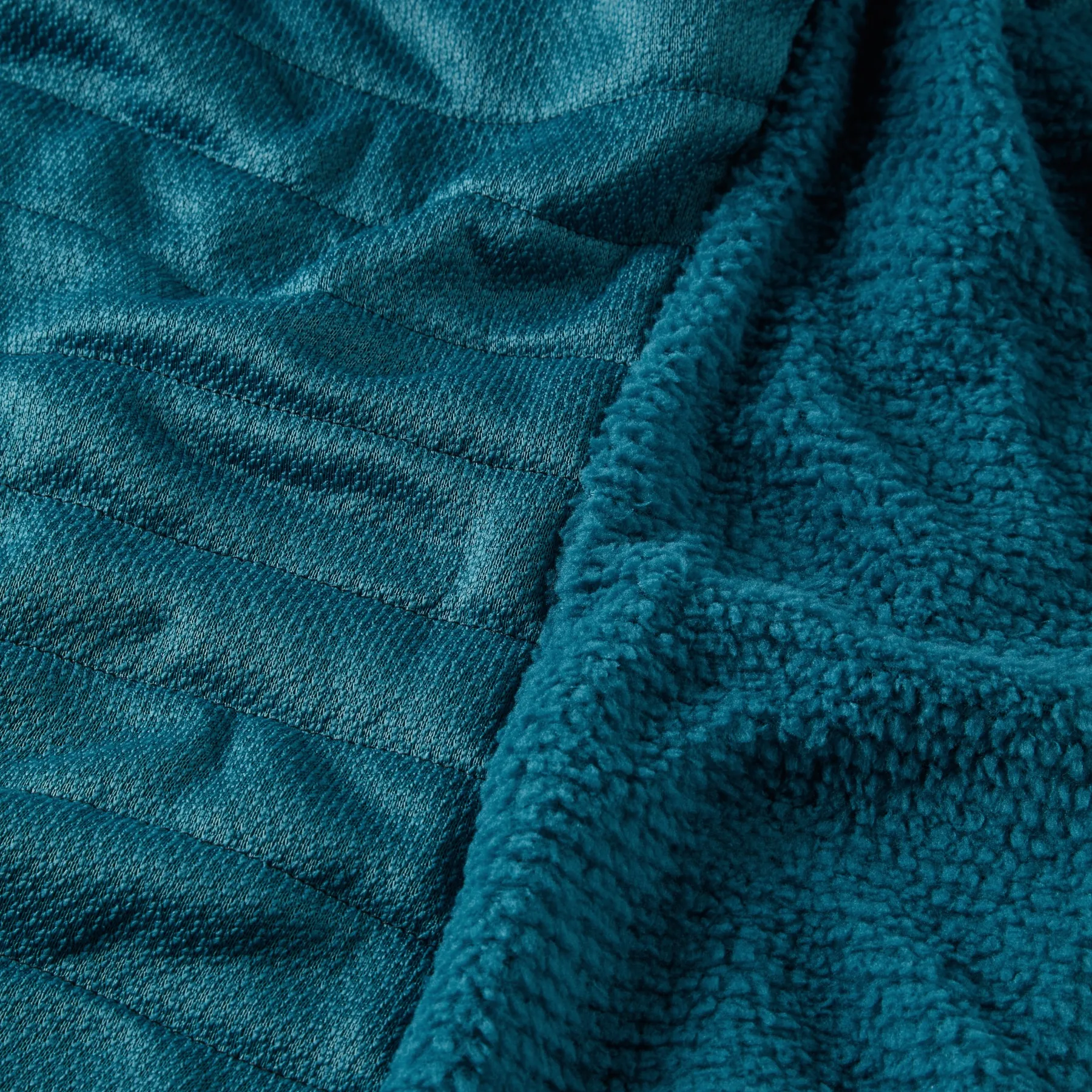 Close-up of the teal insulation lining inside an OMM Mountain Core Jacket